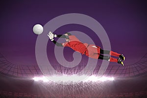 Composite image of fit goal keeper jumping up