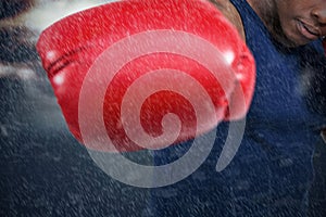 Composite image of fit man boxing with gloves