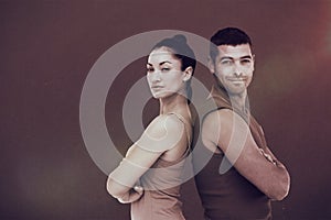 Composite image of fit man and woman smiling at camera together