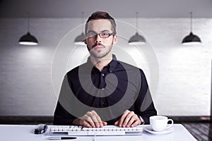 Composite image of focused businessman typing on keyboard