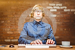 Composite image of focused hipster businessman using computer