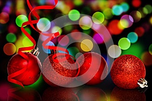 Composite image of four red christmas ball decorations