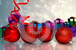 Composite image of four red christmas ball decorations