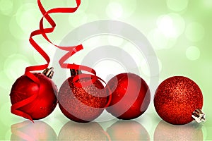 Composite image of four red christmas ball decorations