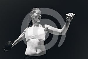 Composite image of front view of sportswoman practising discus throw