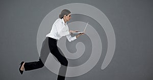 Composite image of full length of businesswoman running while using laptop