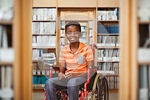 Composite image of full length portrait of happy boy on wheelchair