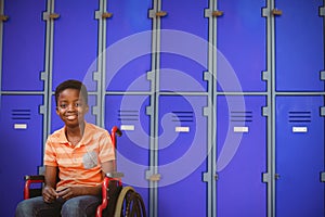 Composite image of full length portrait of happy boy on wheelchair