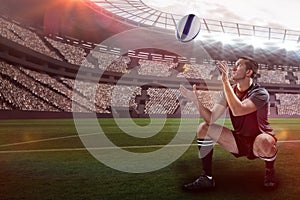 Composite image of full length of rugby player catching the ball with 3d