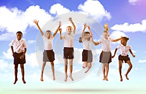 Composite image of full length of students in school uniforms jumping