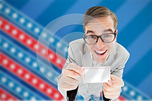 Composite image of geeky hipster smiling and showing card