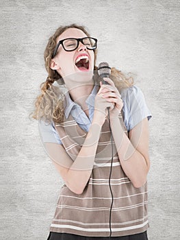 A Composite image of geeky hipster woman singing into a microphone