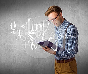 Composite image of geeky student reading a book