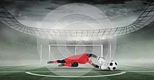 Composite image of goal keeper holding soccer ball in stadium