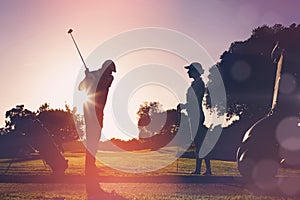 Composite image of golfing couple playing together
