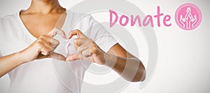 Composite image of graphic image of donate text with breast cancer awareness ribbon