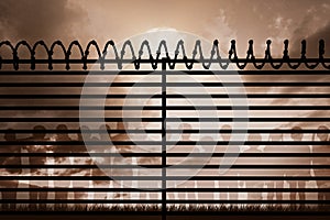 Composite image of graphic image of spiral barbed wire on fence