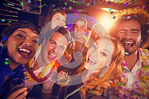 Composite image of group of friends having fun in bar