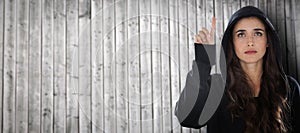 Composite image of hacker using digital screen