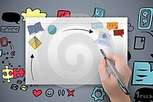 Composite image of hand holding black crayon