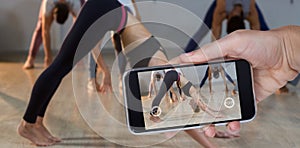 Composite image of hand holding mobile phone against white background