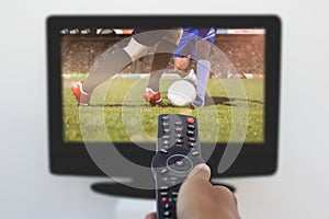 Composite image of hand holding remote and changing channel