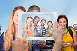 Composite image of hand holding tablet pc