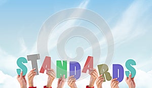 A Composite image of hands holding up standards