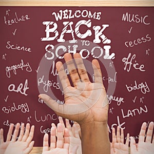 Composite image of hands raising in the air