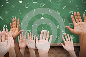 Composite image of hands raising in the air