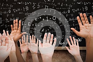 Composite image of hands raising in the air