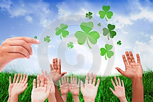 Composite image of hands raising in the air