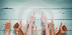 Composite image of hands showing thumbs up