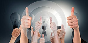 Composite image of hands showing thumbs up