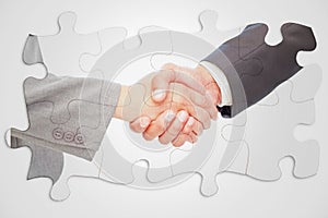 Composite image of handshake between two business people