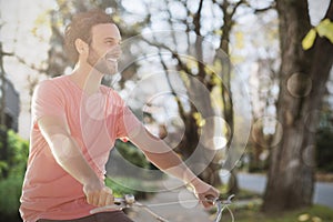 Composite image of handsome man on a bike ride on a sunny day