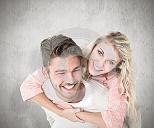 Composite image of handsome man giving piggy back to his girlfriend