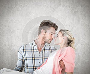 Composite image of handsome man picking up and hugging his girlfriend