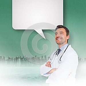 Composite image of handsome young doctor with arms crossed with speech bubble