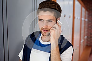Composite image of handsome young man using mobile phone