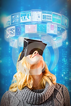 Composite image of happy blond woman using virtual reality headset 3d