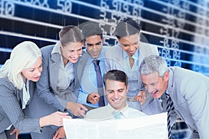 Composite image of happy business people looking at newspaper