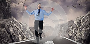 Composite image of happy businessman running with hands up