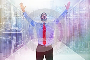 Composite image of happy cheering businessman raising his arms