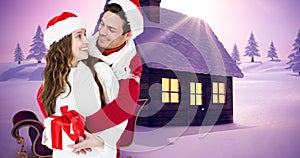 Composite image of happy couple in santa hats with snow covered land in background, copy space