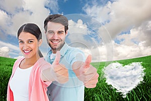Composite image of happy couple showing thumbs up