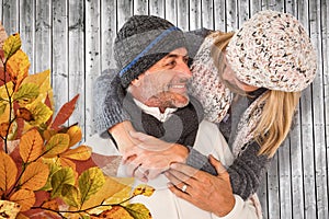 Composite image of happy cute couple romancing while embracing each other