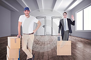 Composite image of happy delivery man leaning on trolley of boxes