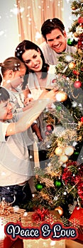 Composite image of happy family decorating a christmas tree with boubles