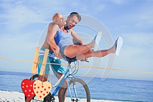 Composite image of happy man giving girlfriend a lift on his crossbar